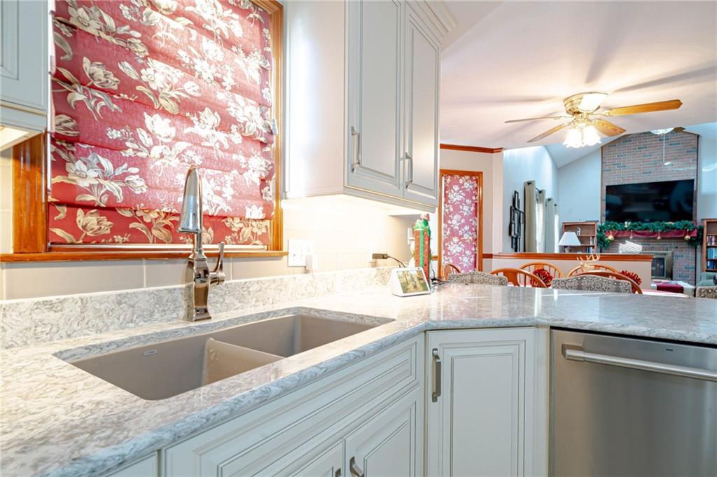 220 Tiffany Irwin, PA 15642 - Photo 9 of 39 a kitchen with a sink cabinets and a wooden floor