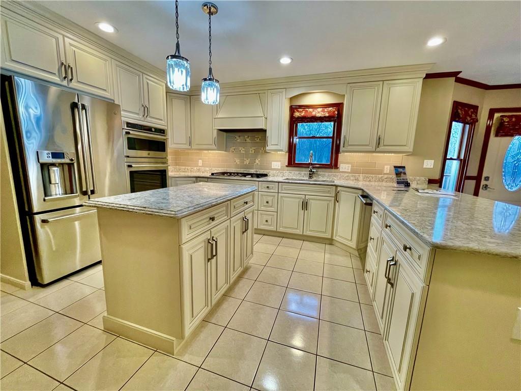220 Tiffany Irwin, PA 15642 - Photo 10 of 39 a kitchen with stainless steel appliances granite countertop a sink a stove a refrigerator a microwave oven with white cabinets and granite countertops