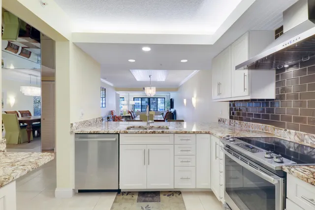 a kitchen with white cabinets and appliances