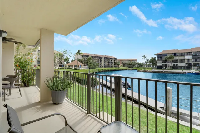 a view of a balcony with two chairs and a table