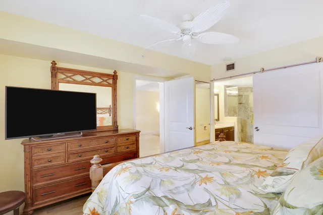 a bedroom with a bed and a flat screen tv