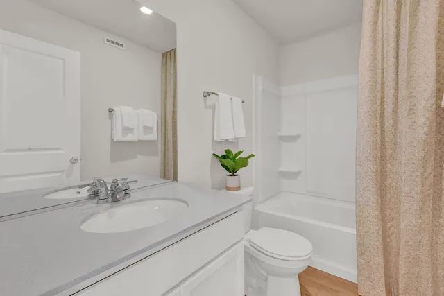 a bathroom with a sink toilet and a mirror