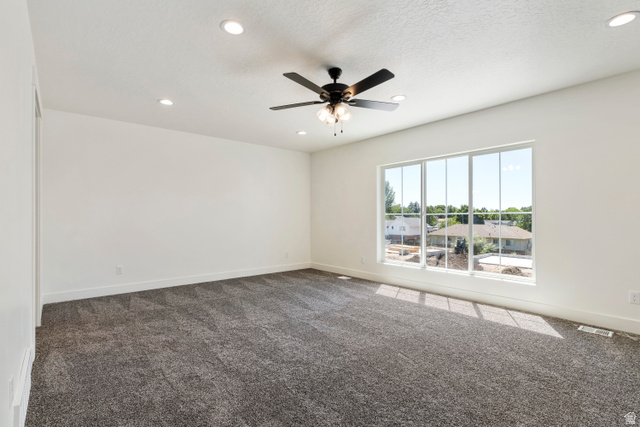 504 North 650 E Street Springville, UT 84663 - Photo 15 of 36 Expansive room featuring a large multi-pane window, recessed lighting, and a ceiling fan with integrated lighting