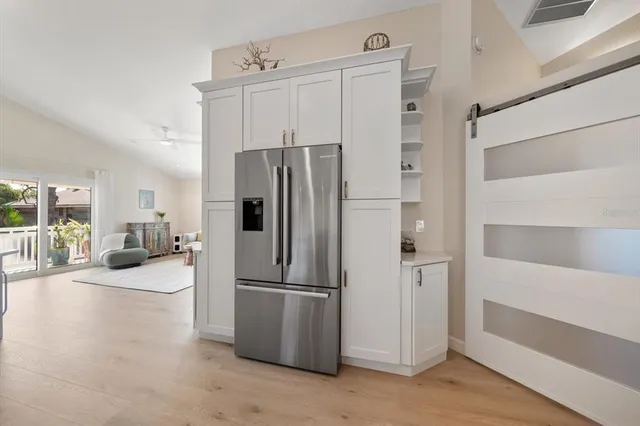 a view of patio with table and chairs under an umbrella