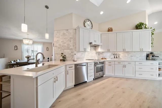 a view of a patio with a table and chairs under an umbrella