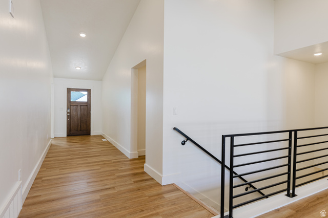 433 North 600 West Smithfield, UT 84335 - Photo 10 of 40 Entryway featuring wood-finish flooring, a dark wood door with glass paneling, recessed lighting, and a contemporary black metal staircase railing
