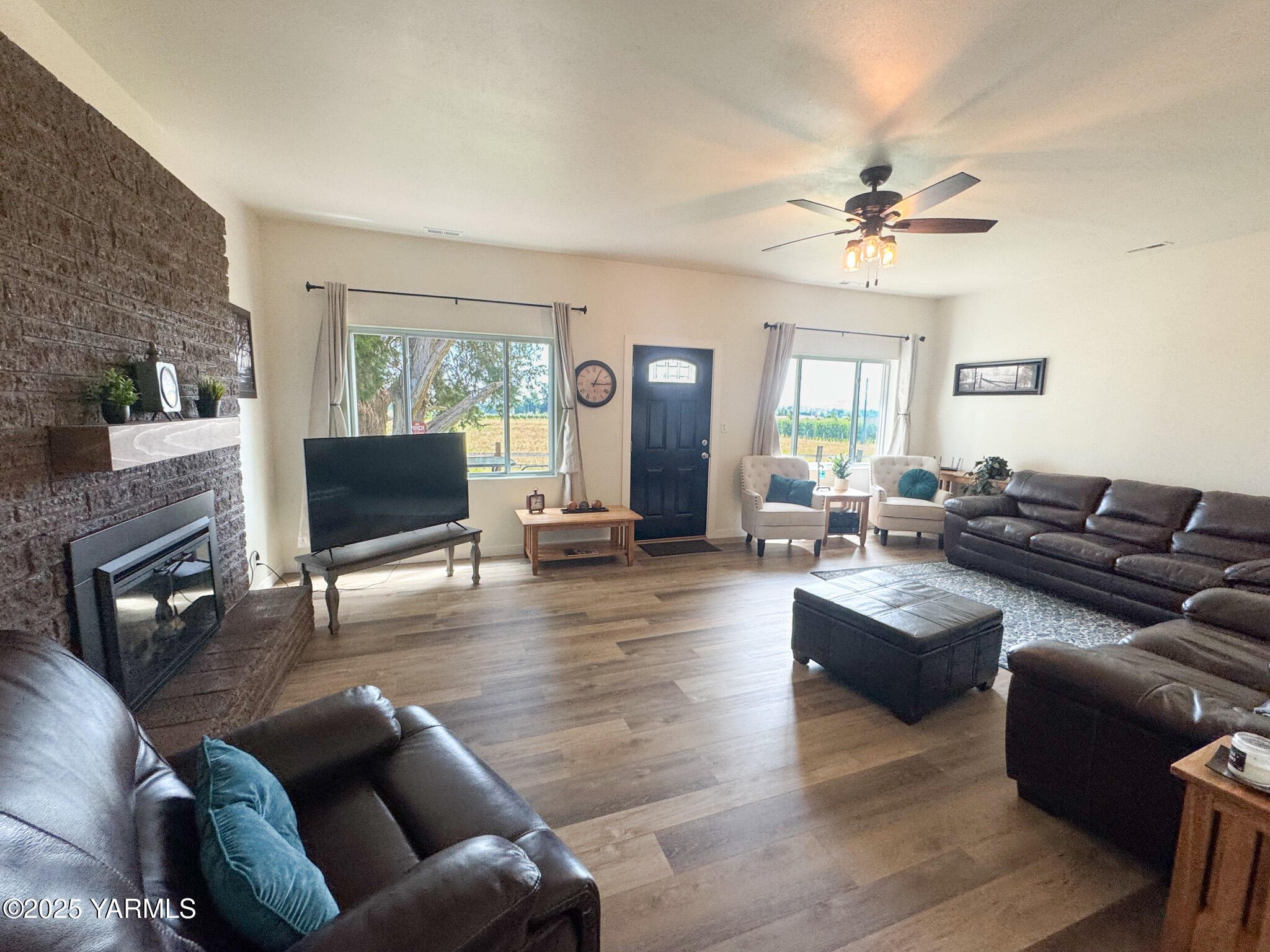 2060 Cemetery Road Sunnyside, WA 98944 - Photo 12 of 29 a living room with furniture a fireplace a flat screen tv and wooden floor