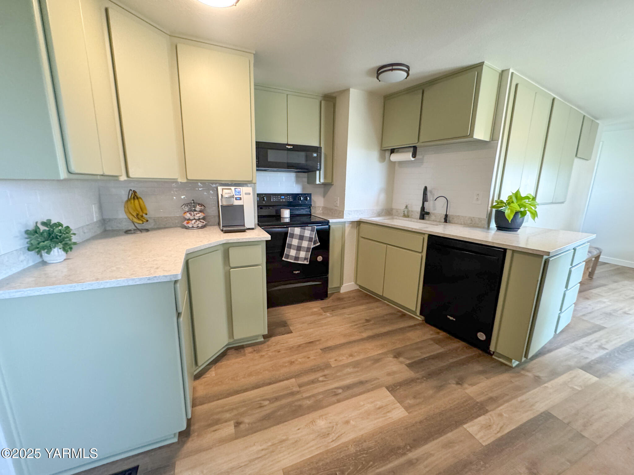 2060 Cemetery Road Sunnyside, WA 98944 - Photo 16 of 29 a kitchen with stainless steel appliances a sink a stove top oven a counter space and cabinets