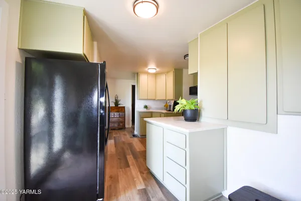 a kitchen with stainless steel appliances granite countertop a refrigerator a sink and a stove