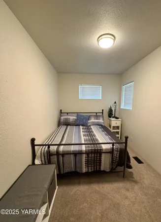 a bed room with a bed and a night stand