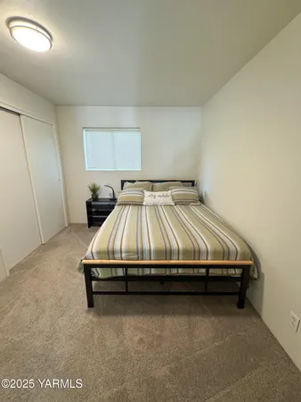 a bedroom with a bed and window