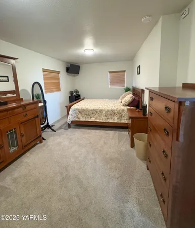 a bed room with furniture and a flat screen tv