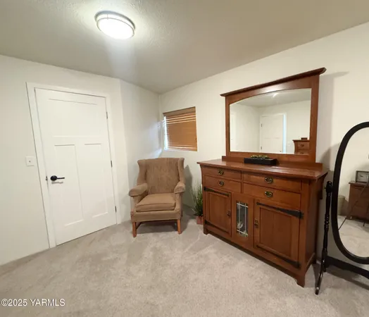 a room with a bed and a mirror on dresser