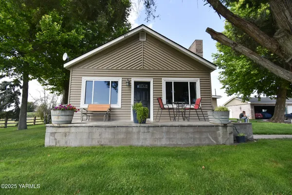 a front view of house with yard and green space