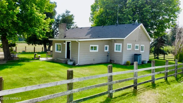 a front view of house with yard and green space