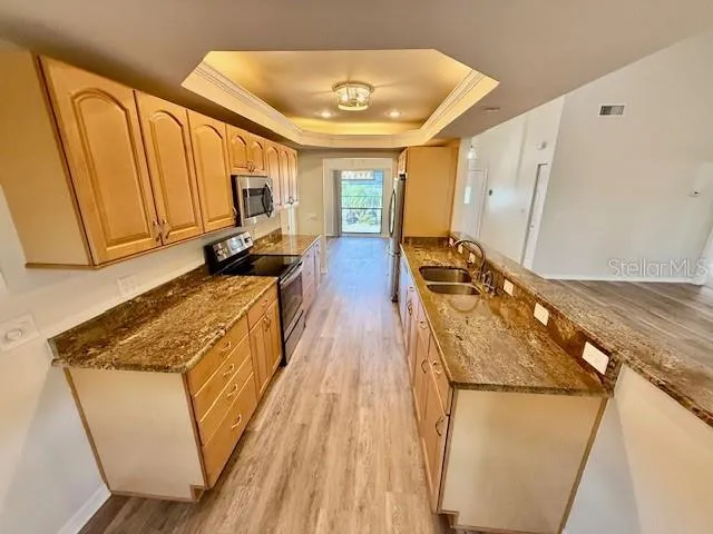 a view of a kitchen with wooden floor and staircase