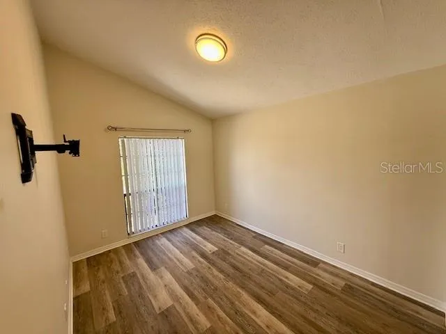 a view of a room with wooden floor and windows