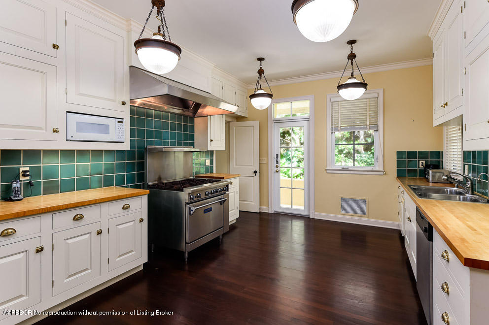 89 Middle Road Palm Beach, FL 33480 - Photo 13 of 23 a kitchen with granite countertop a stove a sink a center island and wooden floor