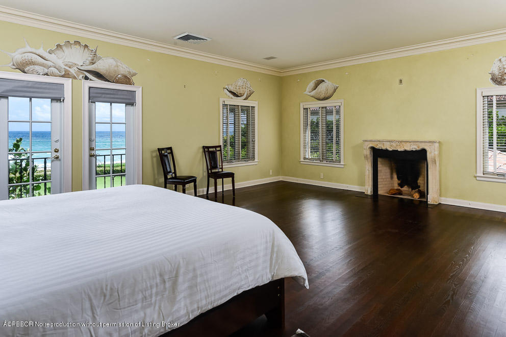 89 Middle Road Palm Beach, FL 33480 - Photo 15 of 23 a spacious bedroom with a bed and wooden floor