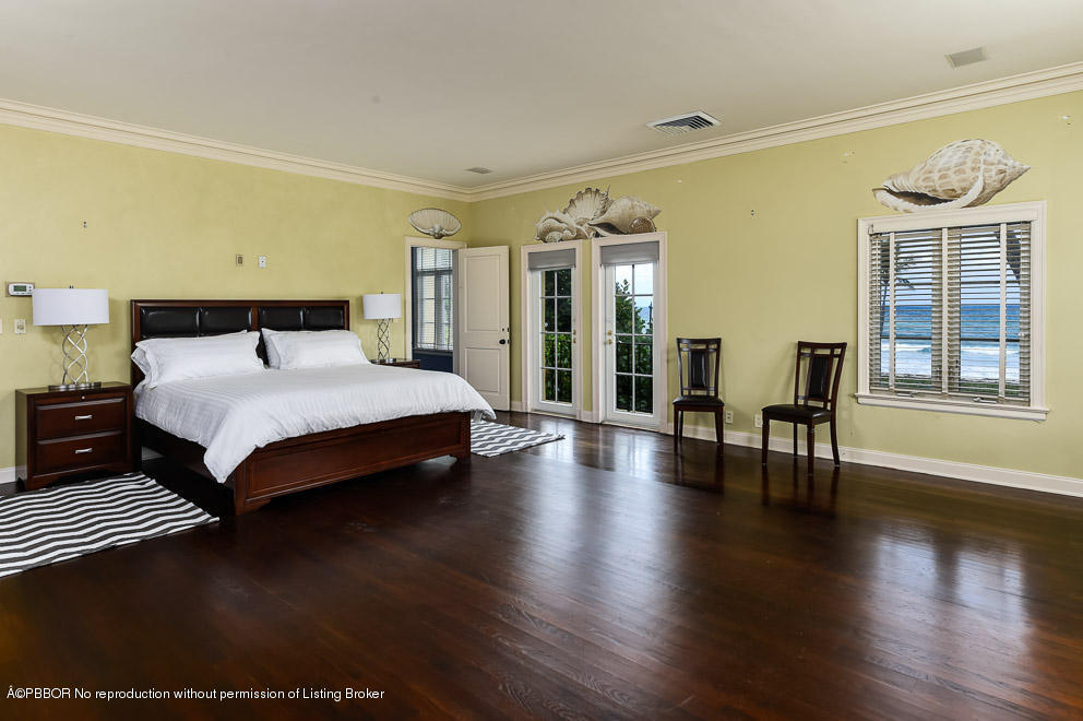 89 Middle Road Palm Beach, FL 33480 - Photo 16 of 23 a bedroom with a bed and wooden floor