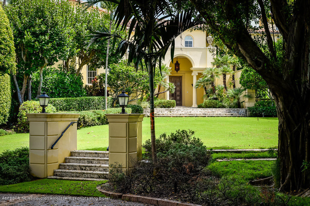 89 Middle Road Palm Beach, FL 33480 - Photo 5 of 23 a front view of a house with a garden and trees