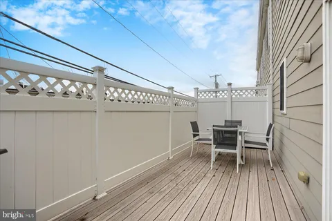 a view of a chairs and table in a balcony