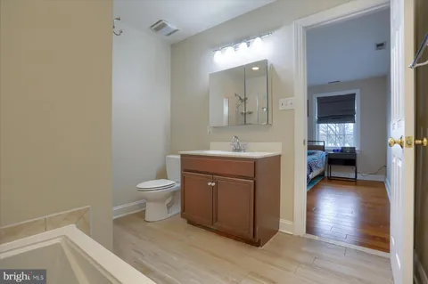 a bathroom with a toilet a sink and mirror