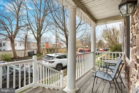 a view of a chair and tables in the balcony