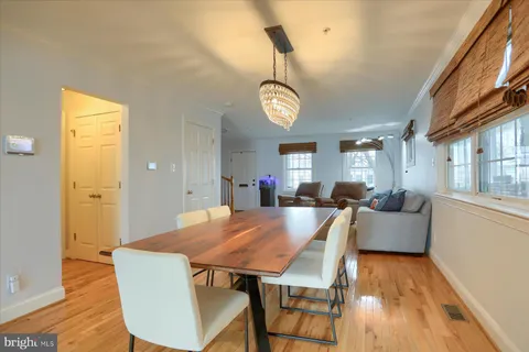 a view of livingroom and dining room with furniture wooden floor