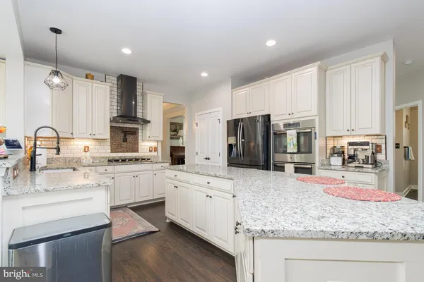 a kitchen with a sink stove cabinets and refrigerator
