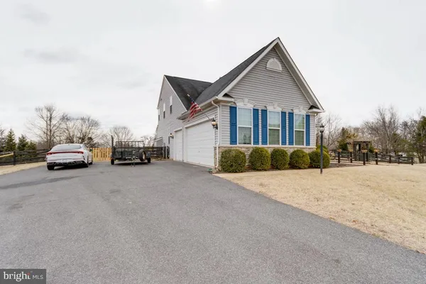 a view of a house with truck parked on a road