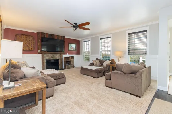a living room with furniture a fireplace and a flat screen tv