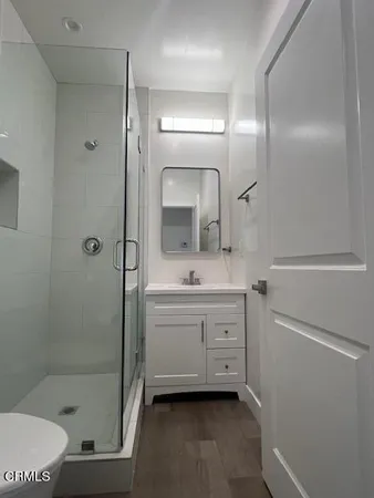 a bathroom with a sink a toilet and shower