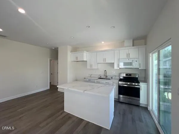 a kitchen with a sink a stove and refrigerator