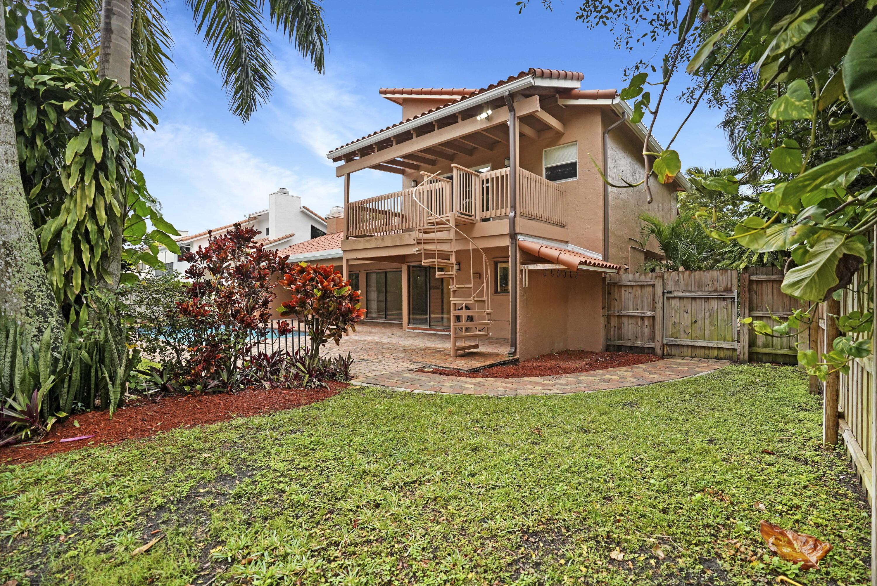 2674 Northwest 41st Street Boca Raton, FL 33434 - Photo 40 of 48 a front view of a house with a yard and garage