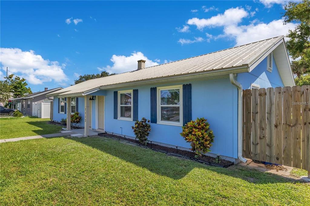 1111 Jersey Avenue St. Cloud, FL 34769 - Photo 2 of 11 a front view of a house with garden