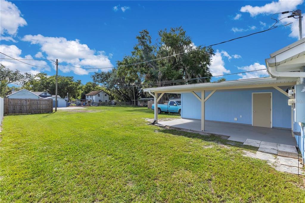 1111 Jersey Avenue St. Cloud, FL 34769 - Photo 3 of 11 a view of a backyard with a garden and entertaining space