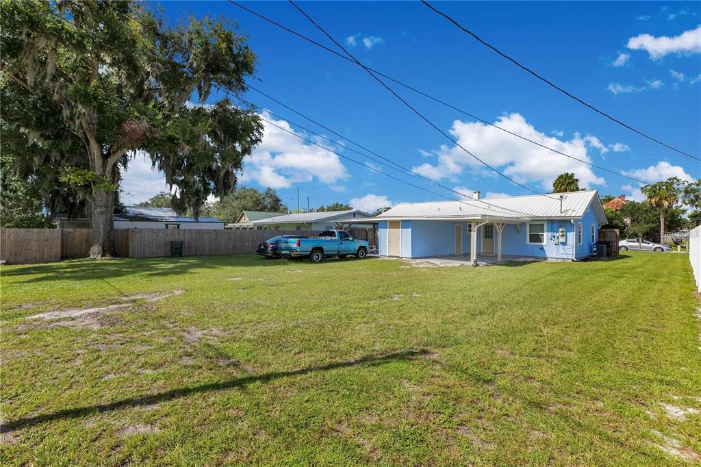 1111 Jersey Avenue St. Cloud, FL 34769 - Photo 4 of 11 a front view of a house with a garden
