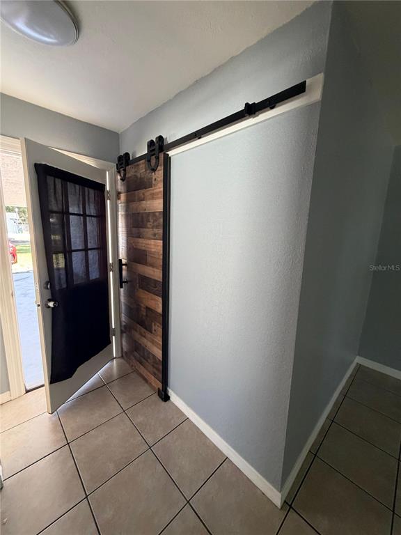 1111 Jersey Avenue St. Cloud, FL 34769 - Photo 8 of 11 a view of walk in closet with empty racks