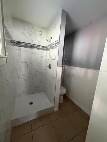 a bathroom with a glass shower door