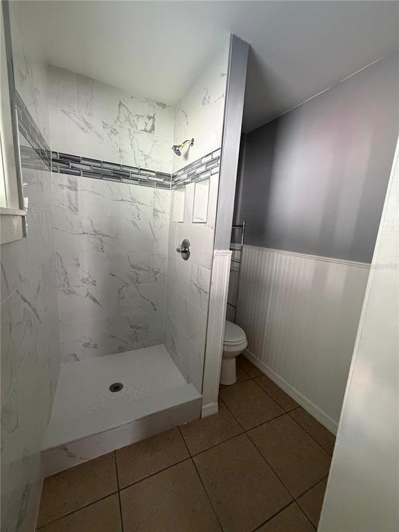 1111 Jersey Avenue St. Cloud, FL 34769 - Photo 10 of 11 a bathroom with a glass shower door