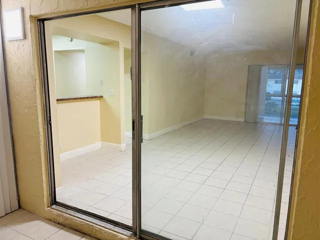 a kitchen with stainless steel appliances granite countertop a sink dishwasher and cabinets with wooden floor
