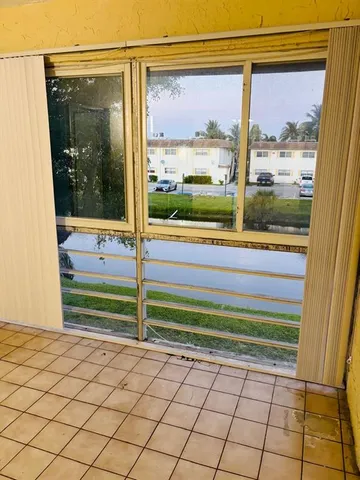 a kitchen with sink a microwave a stove and cabinets