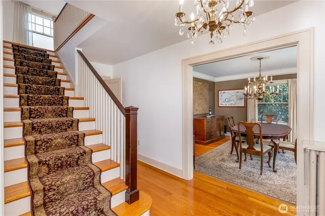 a view of a dining room with furniture wooden floor and a chandelier