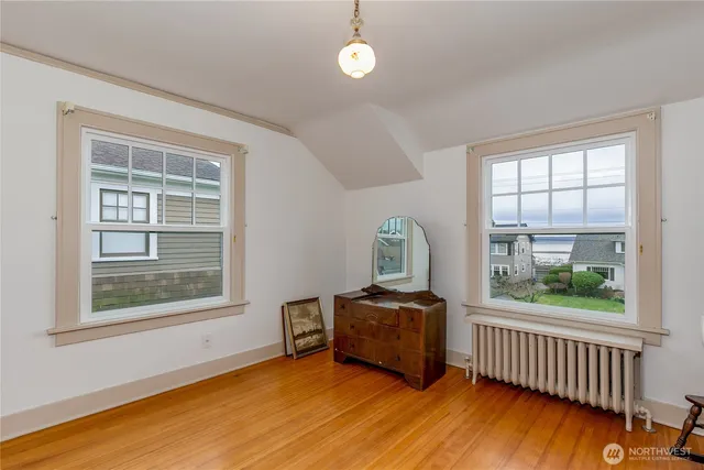 a view of room with window and wooden floor