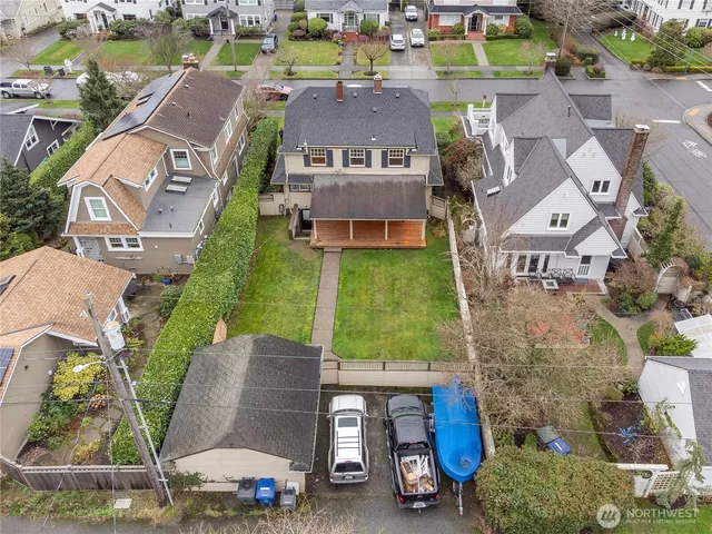 an aerial view of a house with a garden and mountain view in back