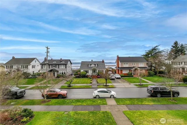 a front view of multiple houses with yard