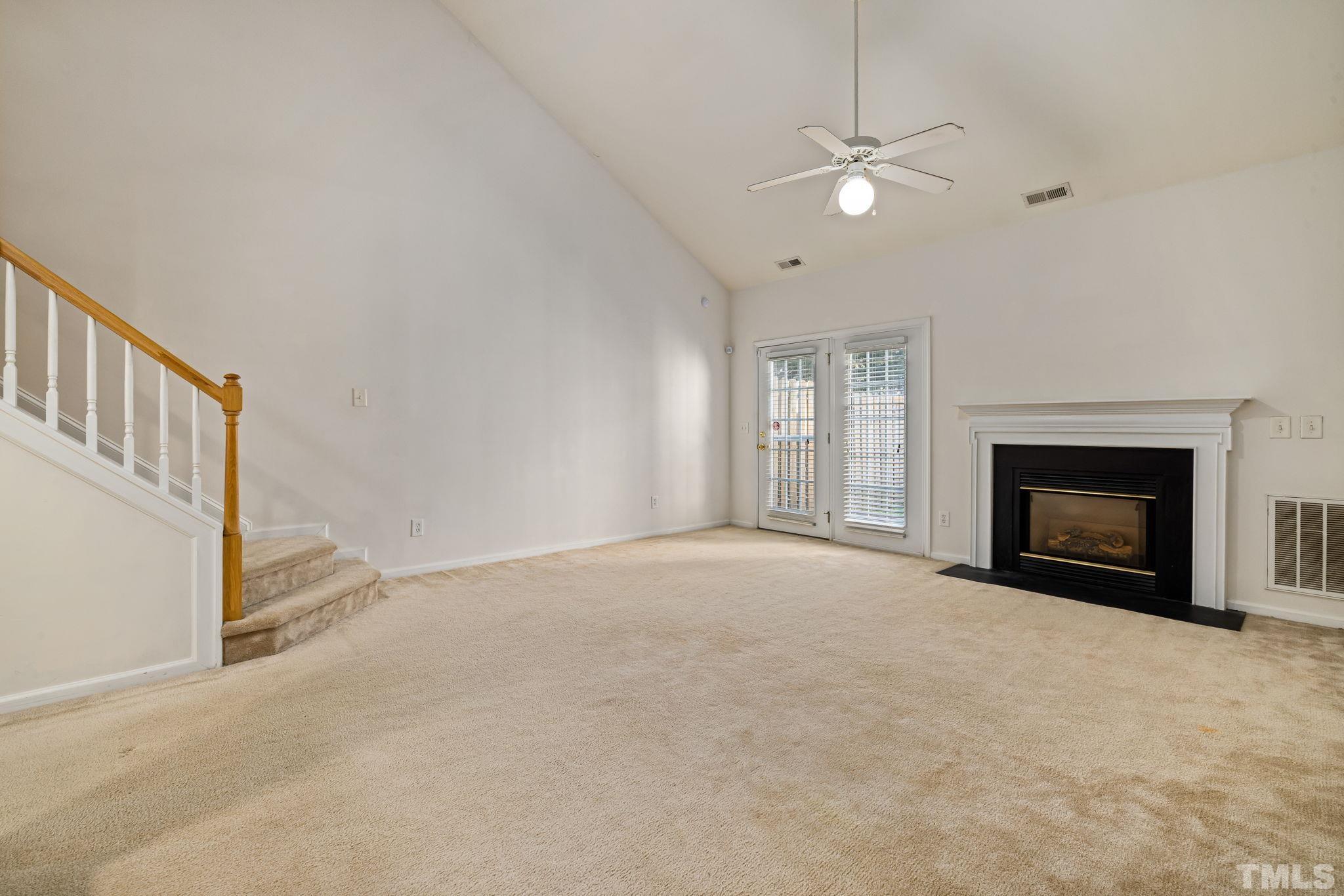 33 Signet Drive Durham, NC 27705 - Photo 18 of 37 a view of an empty room with a fireplace and a window