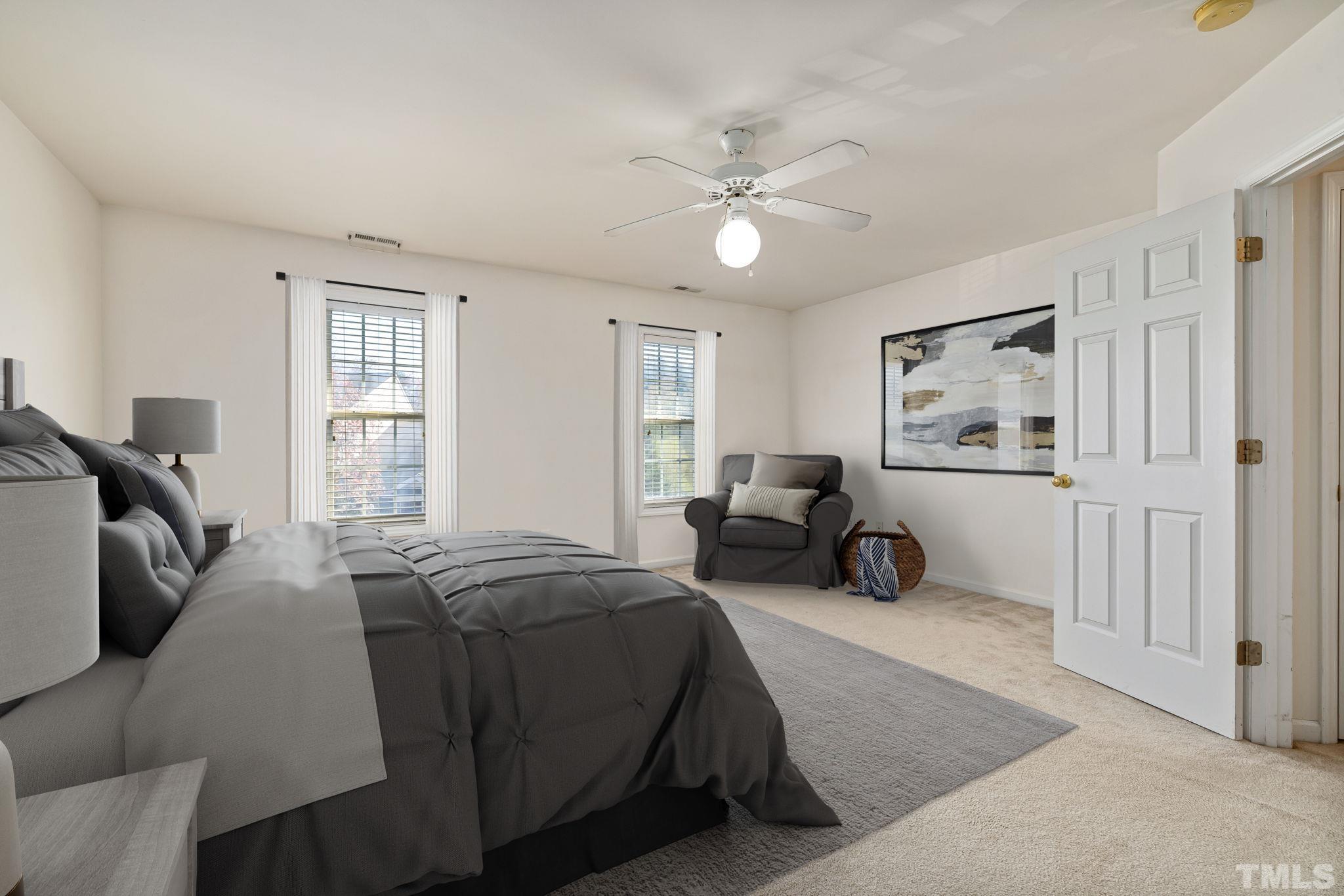 33 Signet Drive Durham, NC 27705 - Photo 28 of 37 a spacious bedroom with a bed a couch and large window