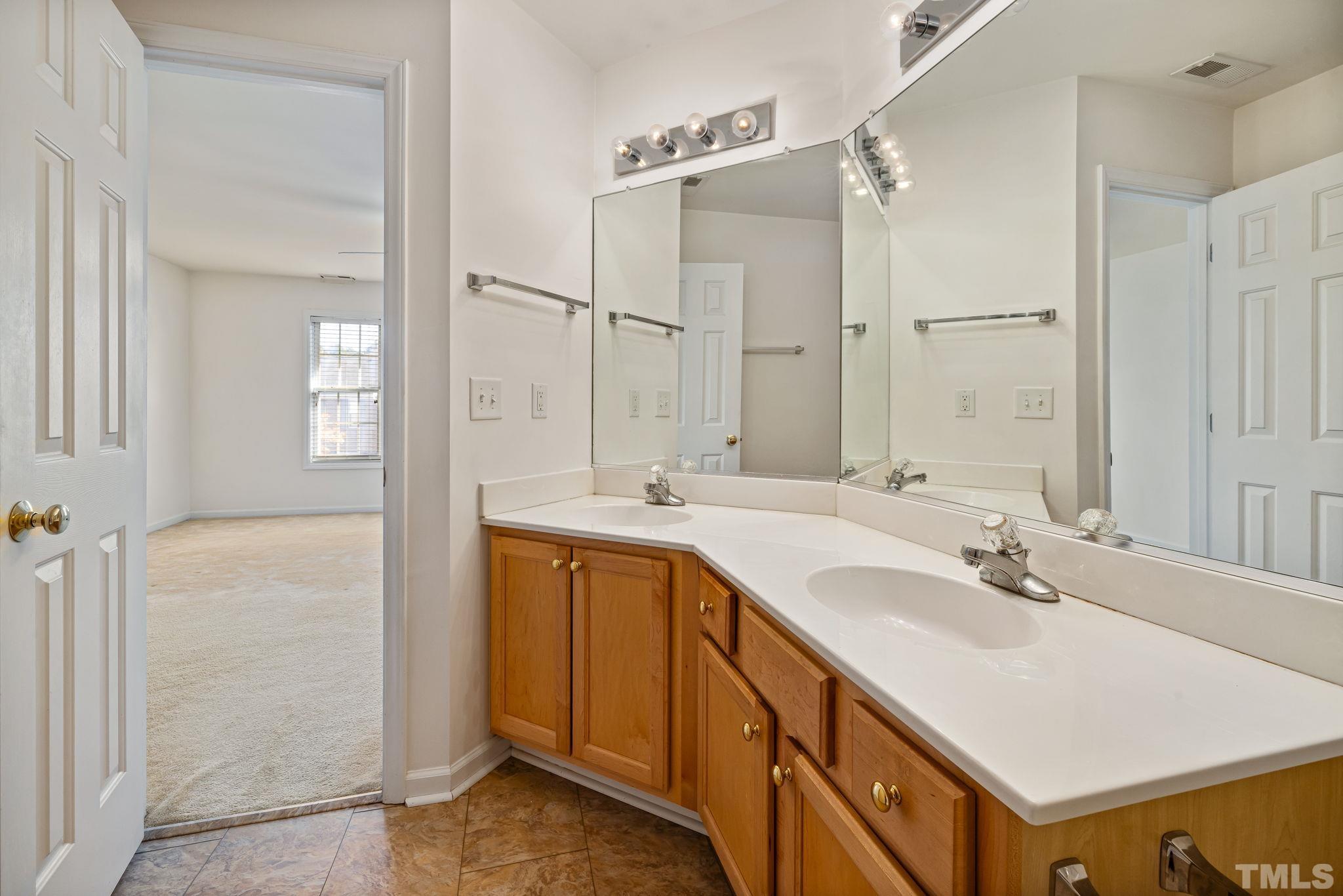 33 Signet Drive Durham, NC 27705 - Photo 32 of 37 a bathroom with a sink double vanity and a mirror